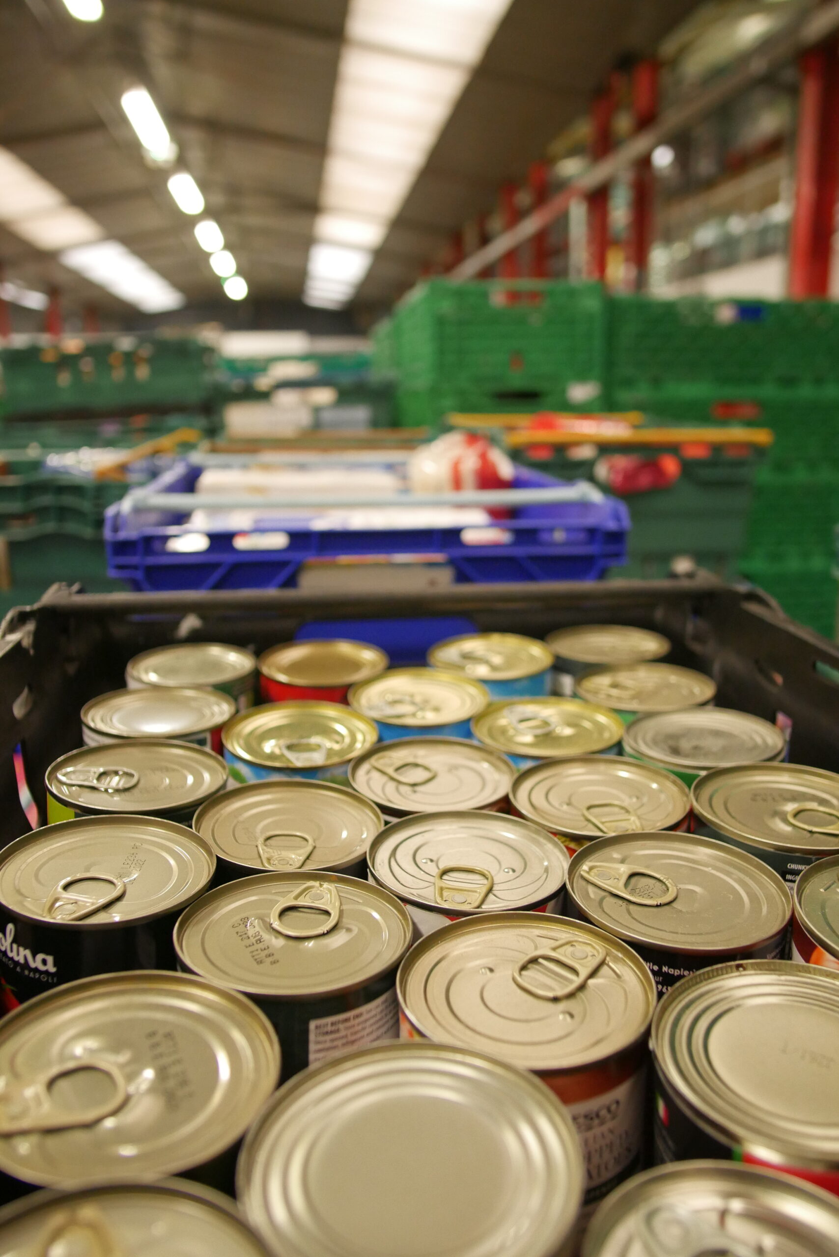 A full box of tins in a large warehouse